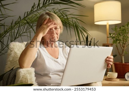 Similar – Image, Stock Photo Frustration in garden office | man sits at table in front of laptop and holds hands in front of face