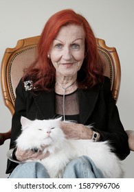 Senior Woman Sitting With Cat On Lap