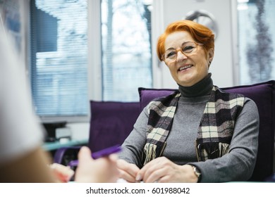 Senior Woman Sitting In A Chair In A Dental Consultation