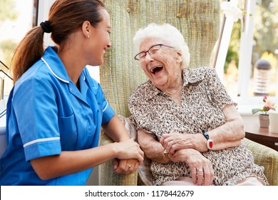 Senior Woman Sitting In Chair And Talking With Nurse In Retirement Home - Shutterstock ID 1178442679