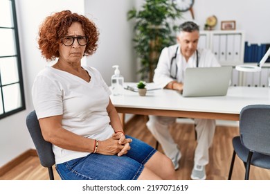 Senior woman sitting at doctor appointment skeptic and nervous, frowning upset because of problem. negative person.  - Shutterstock ID 2197071619