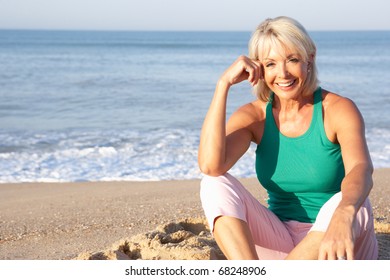 Senior Woman Sitting On Beach Relaxing