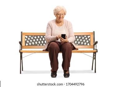 Senior woman sitting on a bench and using a mobile phone isolated on white background - Powered by Shutterstock