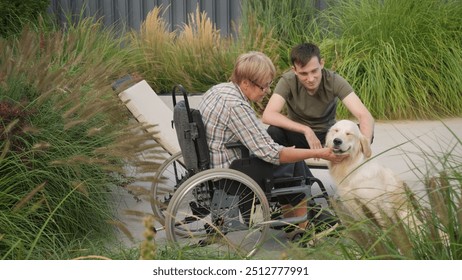 A senior woman sitting in a wheelchair and a young man interact with their happy Golden Retriever in a peaceful garden. The scene captures a touching moment of connection between the elderly woman and - Powered by Shutterstock