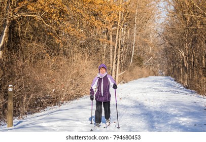 Senior Woman Skiing Cross-country On The Trail In A Park; Winter In Missouri, Midwest