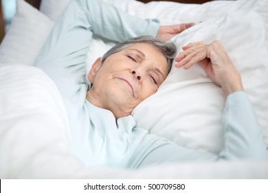 Senior Woman Sleeping In Bed.