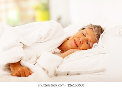 Senior Woman Sleeping On Bed