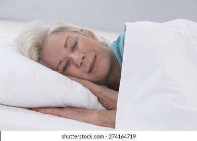 Senior Woman Sleeping On Bed