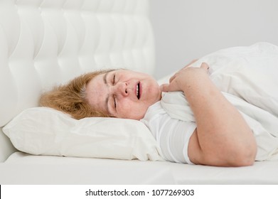 Senior Woman Sleeping And Snoring On The Bed