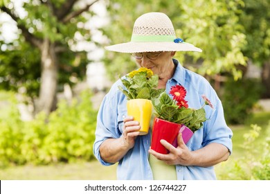 Senior Woman Smelling Flowers