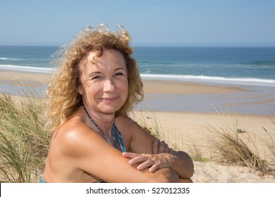 Senior Woman Smiling Near Ocean Beach