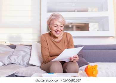 Senior Woman Smilling And Happy About Her Finances. Old Lady Receives A Letter.Senior Lady Receiving Good News From A Paper Mail.