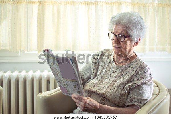 Senior Woman Solving Crossword Puzzle Home Stock Photo Edit Now 1043331967