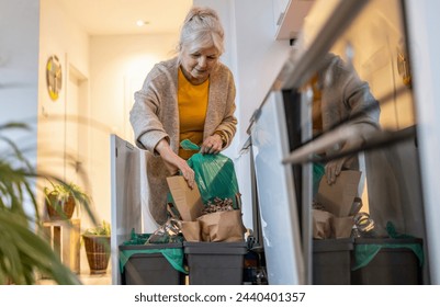 Senior woman sorting garbage in recycling bins at home
 - Powered by Shutterstock