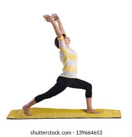 Senior Woman Standing In Yoga Pose On Yellow Matting Isolated On White