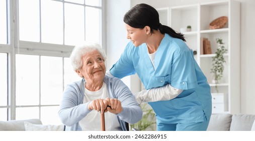 Senior woman with stick and nurse at home - Powered by Shutterstock