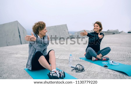 Similar – Two women walking by sea pier