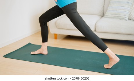 Senior Woman Stretching At Home.