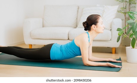 Senior Woman Stretching At Home.