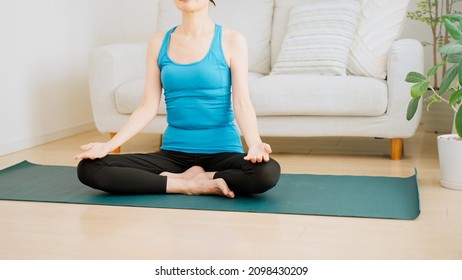 Senior Woman Stretching At Home.