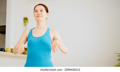 Senior Woman Stretching At Home.