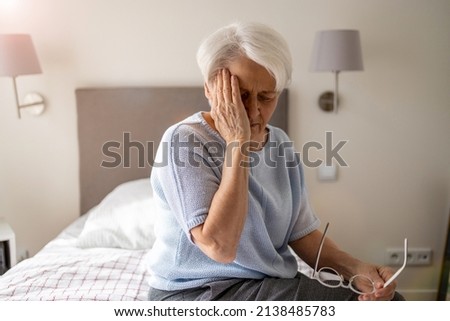 Senior woman suffering from a headache 
