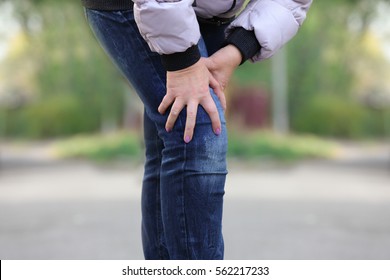 Senior Woman Suffering From Pain In Leg Outdoors, Closeup