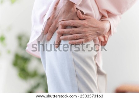 Senior woman suffering from sciatica