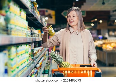 Senior woman in a supermarket chooses groceries in the grocery department - Powered by Shutterstock