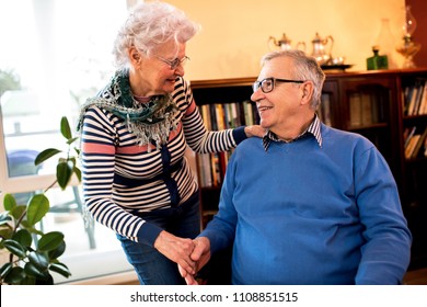 Senior woman take care of her old lovely husband in wheelchair - Powered by Shutterstock