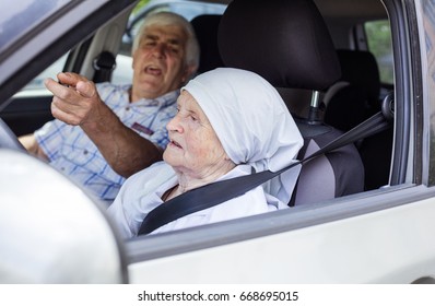 Senior Woman Taking Driving Lesson, Male Instructor Pointing Angrily At Traffic Signs