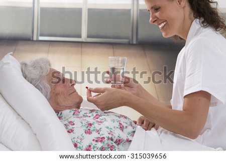 Similar – Female doctor giving medication to elderly patient