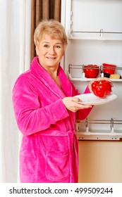 Senior Woman Taking A Red Paprika From Fridge