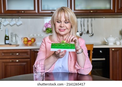 Senior Woman Taking Vitamins From Daily Pill Box