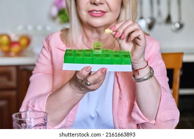 Senior Woman Taking Vitamins From Daily Pill Box