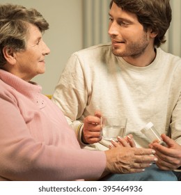 Senior Woman Talking With Male Handsome Caregiver