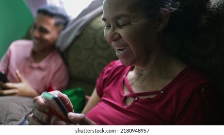 A Senior Woman Talking On Phone Laughing And Smiling. A Hispanic Latin South American Older Person Using Cellphone