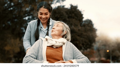 Senior woman, talking and outdoor with caregiver, nurse or healthcare service for person with a disability and wheelchair. Happy, face and elderly lady in park with care and support in retirement - Powered by Shutterstock