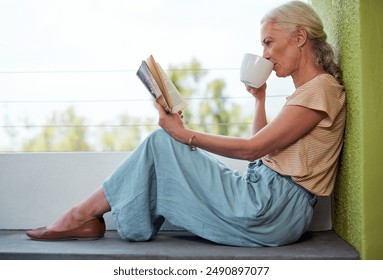 Senior woman, tea and reading in retirement for relax, learning and wellness in morning on weekend. Elderly person, coffee and book on balcony of home for knowledge, storytelling and hobby with cup - Powered by Shutterstock