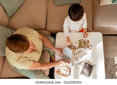 Senior Woman Together With Little Child Counting Money Americain Dollars And Euro At Home Teaching Kid Financial Literacy Planning Budget