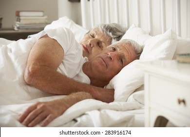 Senior Woman Tries To Be Affectionate Towards Husband In Bed