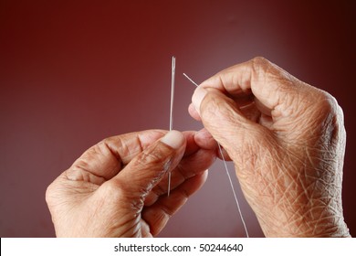 An Senior Woman  Trying To Thread A Needle