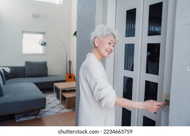 Senior woman using home elevator - Shutterstock ID 2234663759
