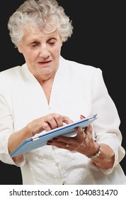 Senior Woman Using Ipad Isolated On Black Background