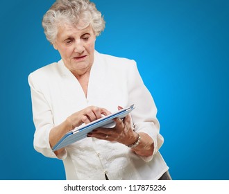 Senior Woman Using Ipad Isolated On Blue Background