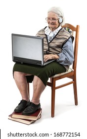 Senior woman using laptop computer isolated on white 