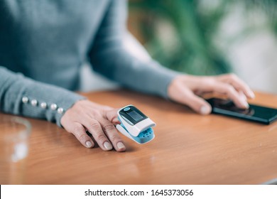 Senior Woman Using Pulse Oximeter and Smart Phone, Measuring Oxygen Saturation - Shutterstock ID 1645373056