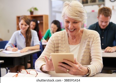 Senior Woman Using Tablet Computer At Adult Education Class