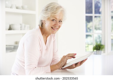 Senior Woman Using Tablet At Home