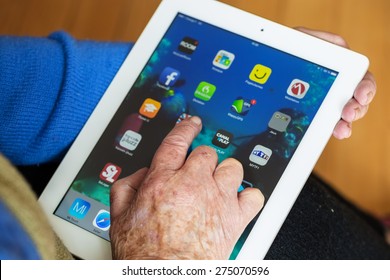 Senior Woman Using Tablet With Many App On A Ipad Screen